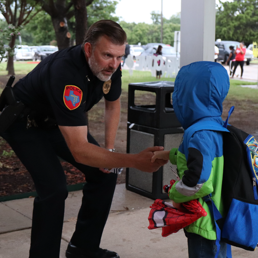 Security Officer Shaking Student Hand